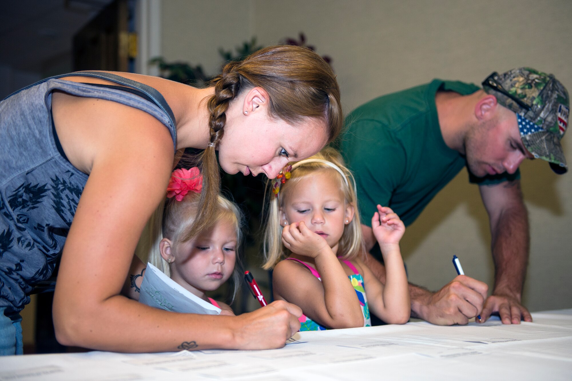 Tiffany Nelson and her husband, U.S. Air Force Staff Sgt. Nicholas Nelson, 23d Maintenance Group quality assurance inspector, sign up for the National Education Fair July 22, 2015, at Moody Air Force Base, Ga. The Information Learning Center hosted the fair for all Airmen, retirees, dependents and civilian contractors to explore their educational options. (U.S. Air Force photo by Airman Greg Nash/Released)