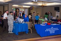 Attendees and education representatives congregate at a National Education Fair July 22, at Moody Air Force Base, Ga. Over 30 colleges participated in the event assisting with attendee’s educational inquiries. (U.S. Air Force photo by Airman Greg Nash/Released)
