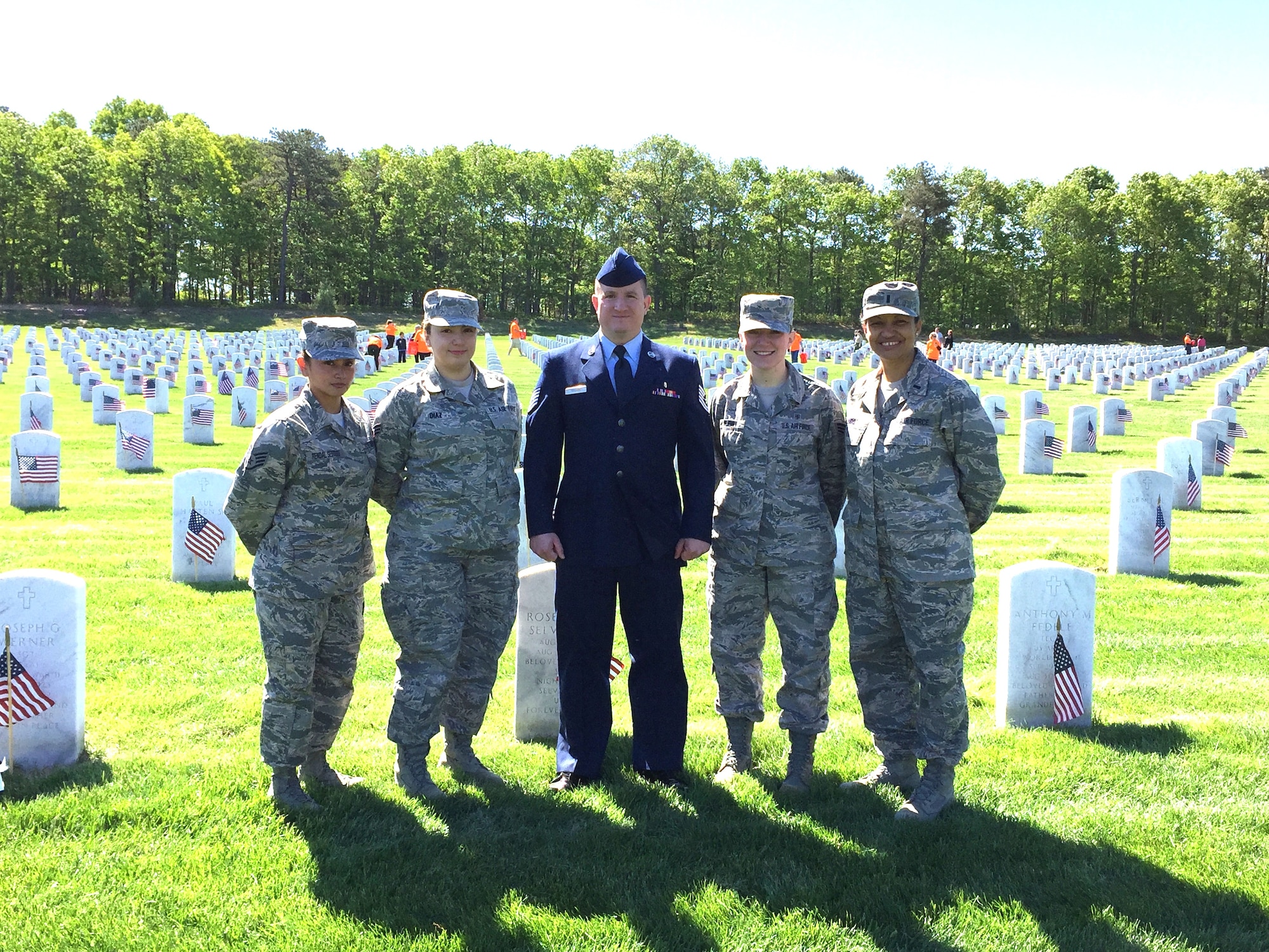 106th Medical Group members and more than 6,700 people decorate gravestones with small American flags at Calverton National Cemetery on Memorial Day weekend, May 23rd 2015.