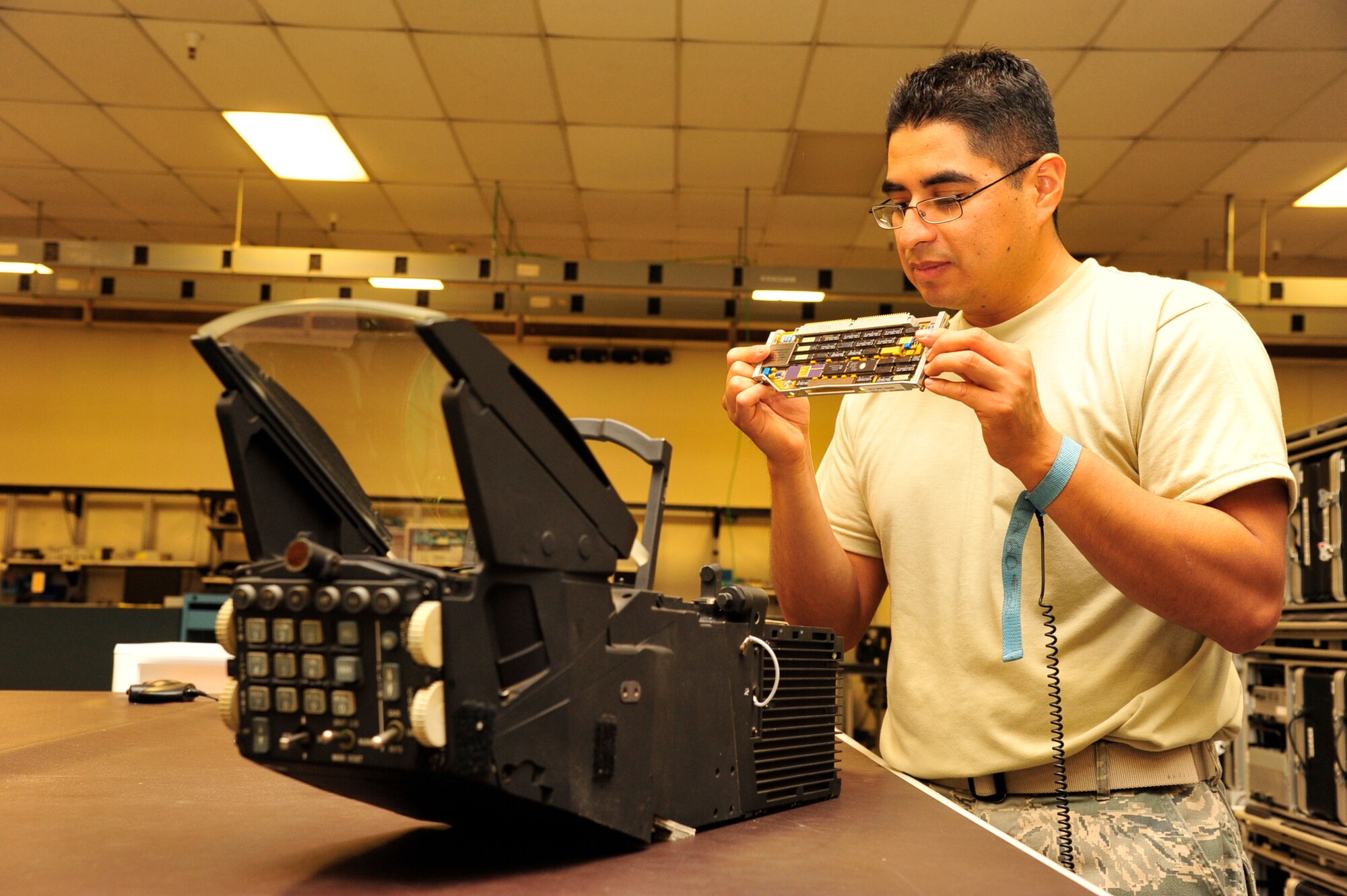 Senior Airman Oswald Reyes, 56th Component Maintenance Squadron Avionics Intermediate Shop technician, inspects the circuit card assembly of a heads-up display for possible component damage at Luke Air Force Base. AIS Airmen screen anything from radars to flight control systems to radios and audio panels. 