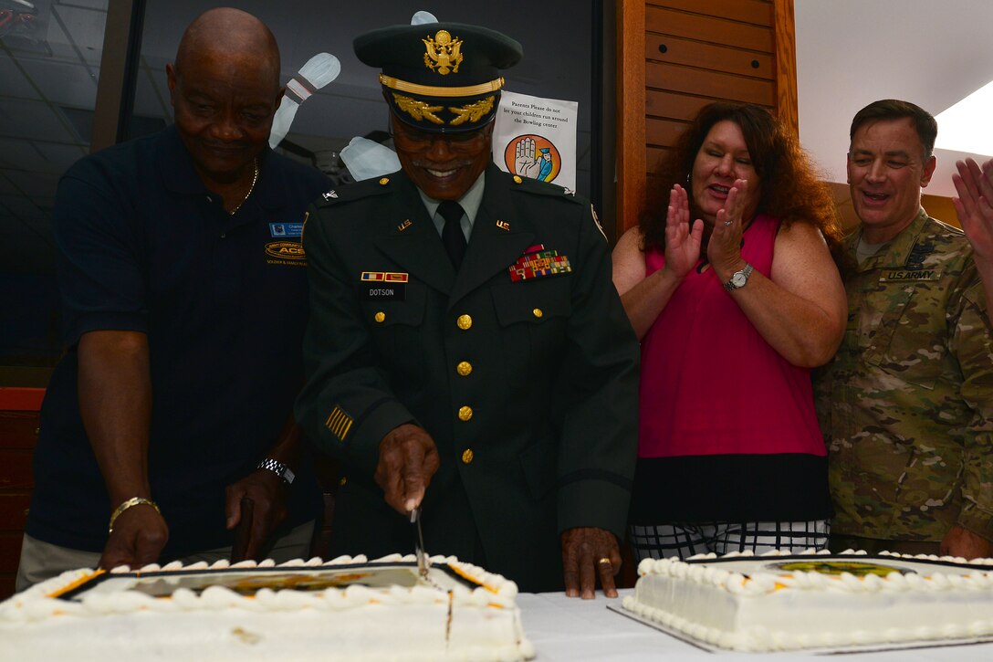 Retired U.S. Army Col. Aaron Dotson cuts the Army Community Service’s birthday cake during its birthday party at Fort Eustis, Va., July 22, 2015. Attendees celebrated the support ACS has contributed to the Army for the past 50 years. (U.S. Air Force photo by Staff Sgt. Natasha Stannard/Released)