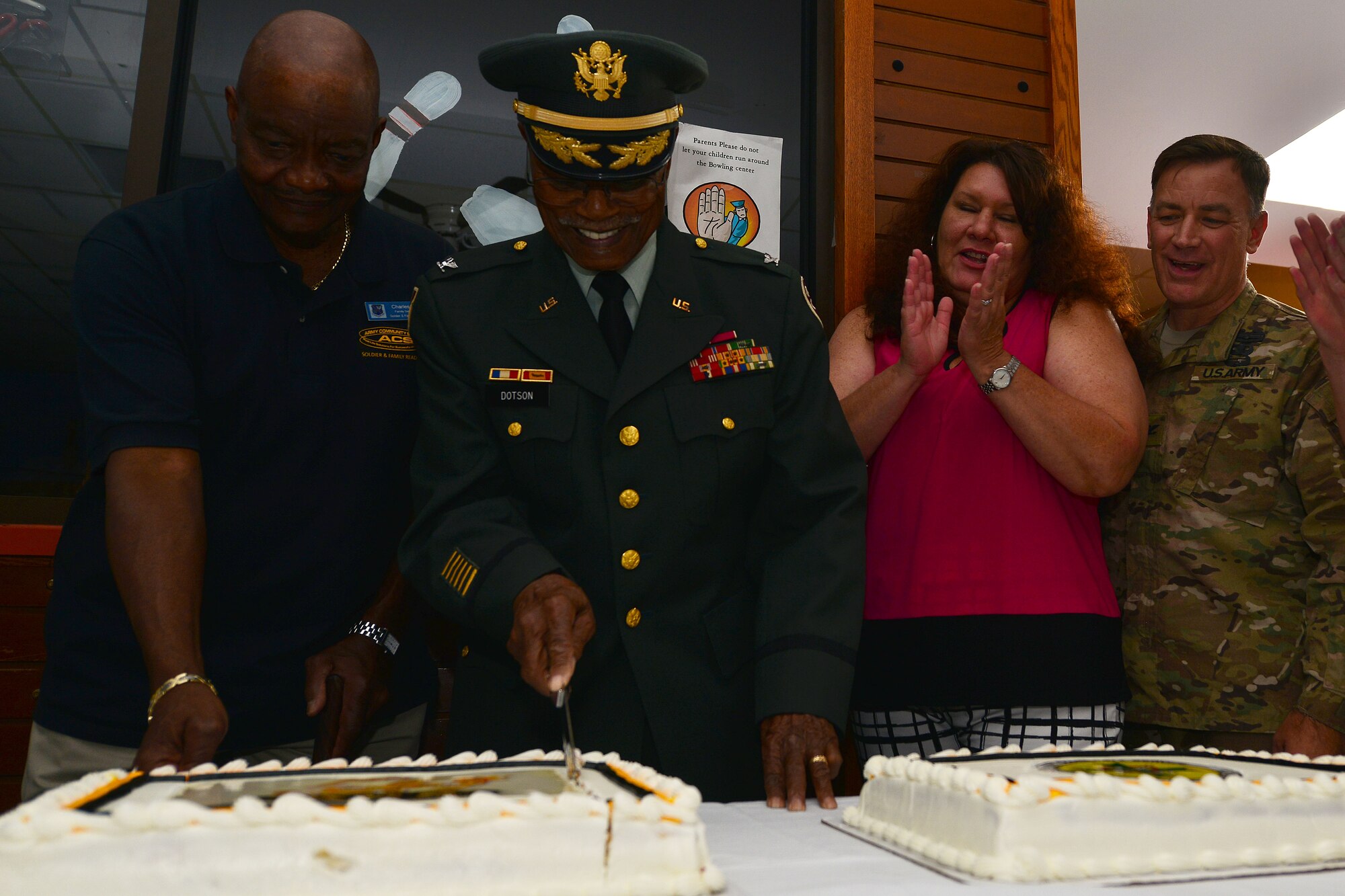 Retired U.S. Army Col. Aaron Dotson cuts the Army Community Service’s birthday cake during its birthday party at Fort Eustis, Va., July 22, 2015. Attendees celebrated the support ACS has contributed to the Army for the past 50 years. (U.S. Air Force photo by Staff Sgt. Natasha Stannard/Released)