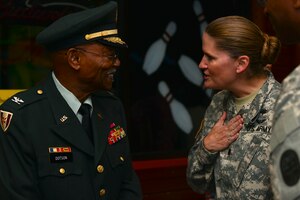 Retired U.S. Army Col. Aaron Dotson speaks with Lt. Col. Heidi Mon, McDonald Army Health Center commander, during the Army Community Service’s birthday party at Fort Eustis, Va., July 22, 2015. The ACS serves as a comprehensive, coordinated and responsive framework of all services that provide readiness to Soldiers, civilian employees and their families. (U.S. Air Force photo by Staff Sgt. Natasha Stannard/Released)