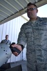 2nd Lt. Dakota Kauffman, 270th Engineering Installation Squadron project engineer, clears his pistol in preparation for transport of the 111th Attack Wing’s marksmanship team to the Governor’s Twenty competition. The top 20 competitors are awarded embroidered emblems and certificates distinguishing them as being a member of “The Governor’s Twenty” during this annual National Guard-wide event. (U.S. Air National Guard photo by Tech. Sgt. Andria Allmond/Released)