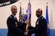 U.S. Air Force Maj. Rahsul Freeman, incoming 20th Logistics Readiness Squadron commander, receives the unit guidon from Col. John Thomas, 20th Mission Support Group commander, during the 20th LRS change of command ceremony at Shaw Air Force Base, S.C., July 23, 2015. The 20th LRS consists of four flights: deployment and distribution, fuels management, material management, and vehicle management. (U.S. Air Force photo by Senior Airman Jonathan Bass/Released)
