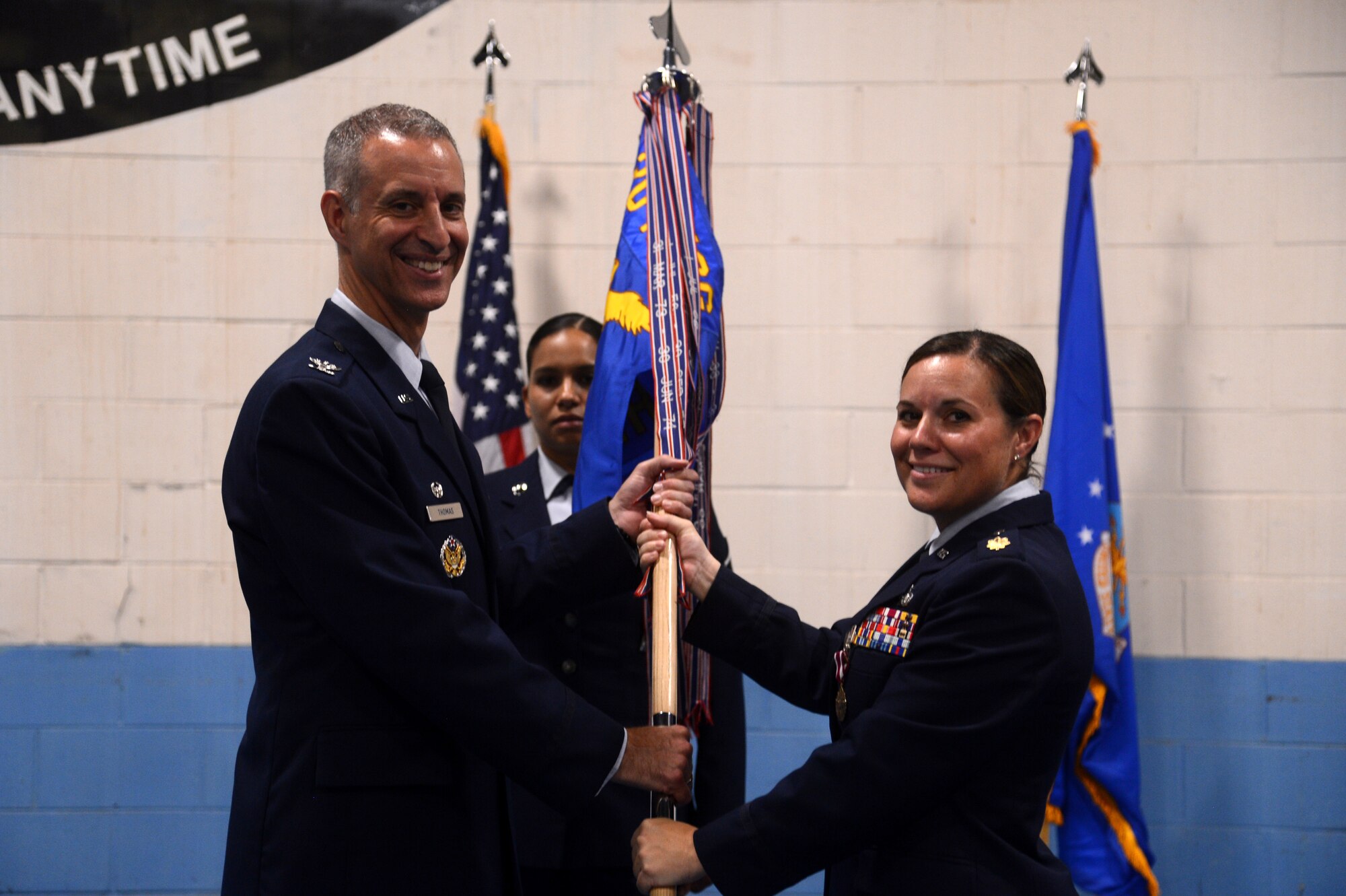 U.S. Air Force Maj. Jamie Wade, outgoing 20th Logistics Readiness Squadron commander, passes the unit guidon to Col. John Thomas, 20th Mission Support Group commander, during the 20th LRS change of command ceremony at Shaw Air Force Base, S.C., July 23, 2015. The 20th LRS consists of more than 350 military and civilian personnel orchestrating the deployment, employment, and redeployment of 79 F-16CM Fighting Falcon aircraft, support personnel, and equipment. (U.S. Air Force photo by Senior Airman Jonathan Bass/Released)