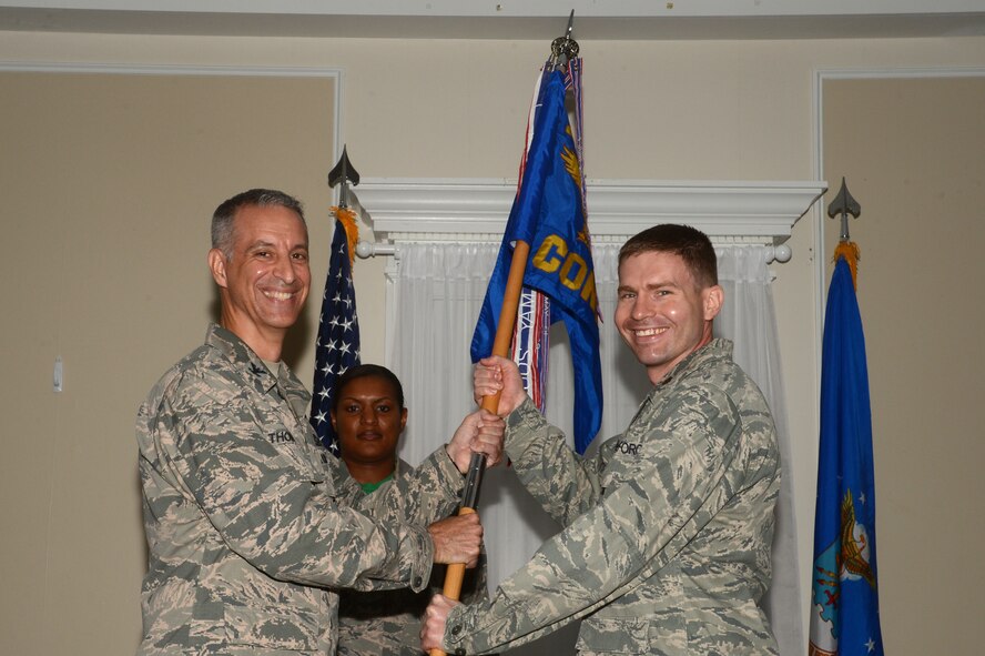 U.S. Air Force Maj. Christopher Jones, 20th Contracting Squadron commander, receives the unit guidon from Col. John Thomas, 20th Mission Support Group commander, during the 20th CONS assumption of command ceremony at Shaw Air Force Base, S.C., July 24, 2015. Jones commissioned through the Air Force ROTC program at the University of Arkansas in 2004 and has been a contracting officer his entire career. Annually, 20th CONS purchases $168 million in contracts for construction, services and supplies to support the missions of the 20th Fighter Wing and Ninth Air Force, as well as the U.S. Air Forces Central. (U.S. Air Force photo by Senior Airman Jonathan Bass/Released)
