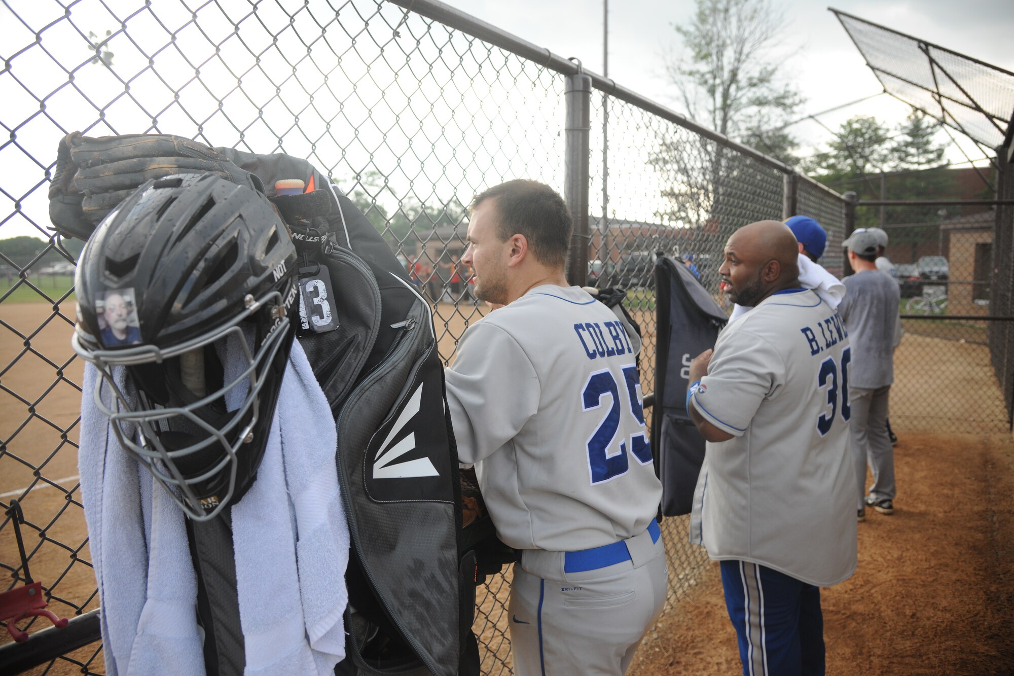 Members of the 1st Helicopter Squadron stand in the dugout to watch the Joint Base Andrews’ championship softball game, July 21, 2015, at the West Fitness Center softball fields. The 174th Air Defense Artillery Brigade softball team won two games against the 1st Helicopter Squadron softball team to win the championship. (U.S. Air Force photo/ Airman 1st Class J.D. Maidens)