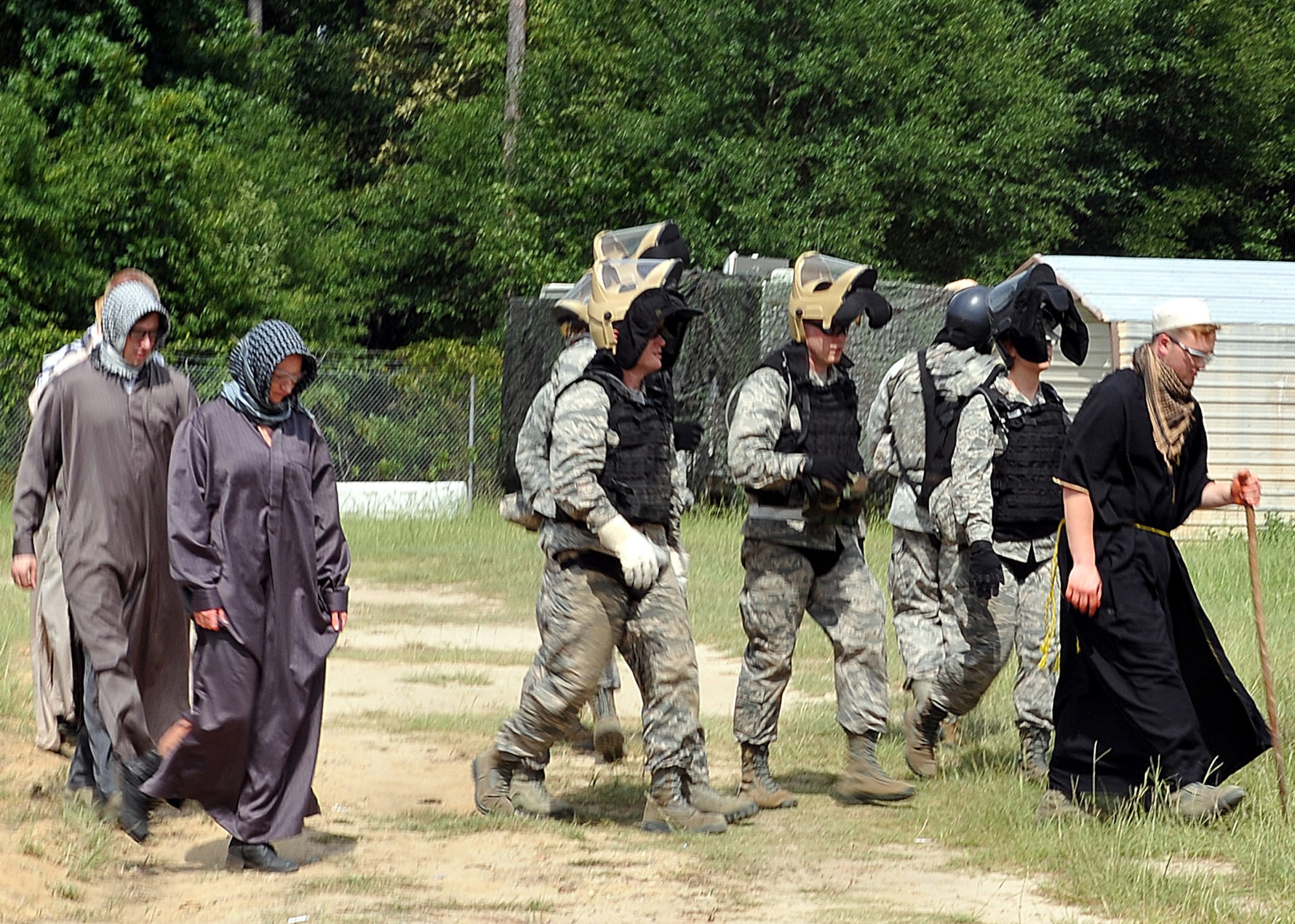 Chaplain candidates simulate accompanying local villagers in Africa during a training exercise at Gator Air Base. As part of a church group, they provided local nationals with food, water, medical and spiritual aid. (U.S. Air Force photo by Tommie Horton)
