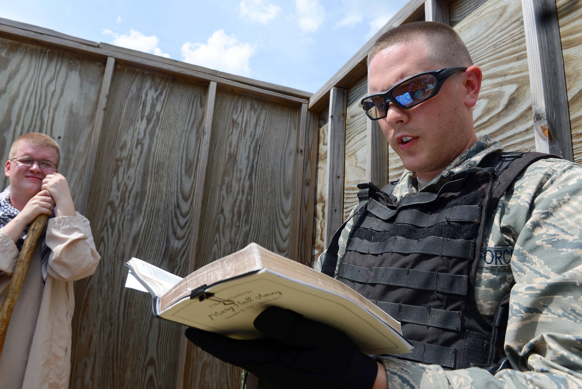 Second Lt. Nathan Newman reads from a bible during an exercise with the 5th Combat Communications Group at Gator Air Base. It was the first time chaplains participated in combat training with the unit. (U.S. Air Force photo by Tommie Horton)