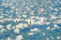 Five members of the U.S. Air Force Thunderbirds fly in formation behind a KC-135 Stratotanker assigned to McConnell Air Force Base, Kan., after refueling en route to their next performance, July 23, 2015. The refueling sortie was the final flight for the 22nd Air Refueling Wing vice commander, Col. James Dermer, and the Thunderbirds honored his 24 years of service with this formation. (U.S. Air Force photo by Senior Airman Victor J. Caputo)