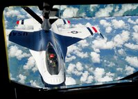A member of the U.S. Air Force Thunderbirds takes fuel from a KC-135 Stratotanker assigned to McConnell Air Force Base, Kan., July 23, 2015. The Thunderbirds are the Air Force’s premiere air demonstration team and perform in different shows across the nation. KC-135s or other tanker aircraft often accompany the group as the transit from one location to another due to the low fuel capacity of the F-16 Fighting Falcon. (U.S. Air Force photo by Senior Airman Victor J. Caputo)