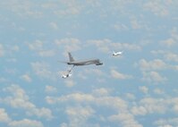 A KC-135 Stratotanker assigned to McConnell Air Force Base, Kan., refuels two members of the U.S. Air Force Thunderbirds, July 23, 2015. Two KC-135s from McConnell refueled the Thunderbirds as they transited from Wyoming to Wisconsin for another aerial demonstration. (U.S. Air Force photo by Senior Airman Victor J. Caputo)