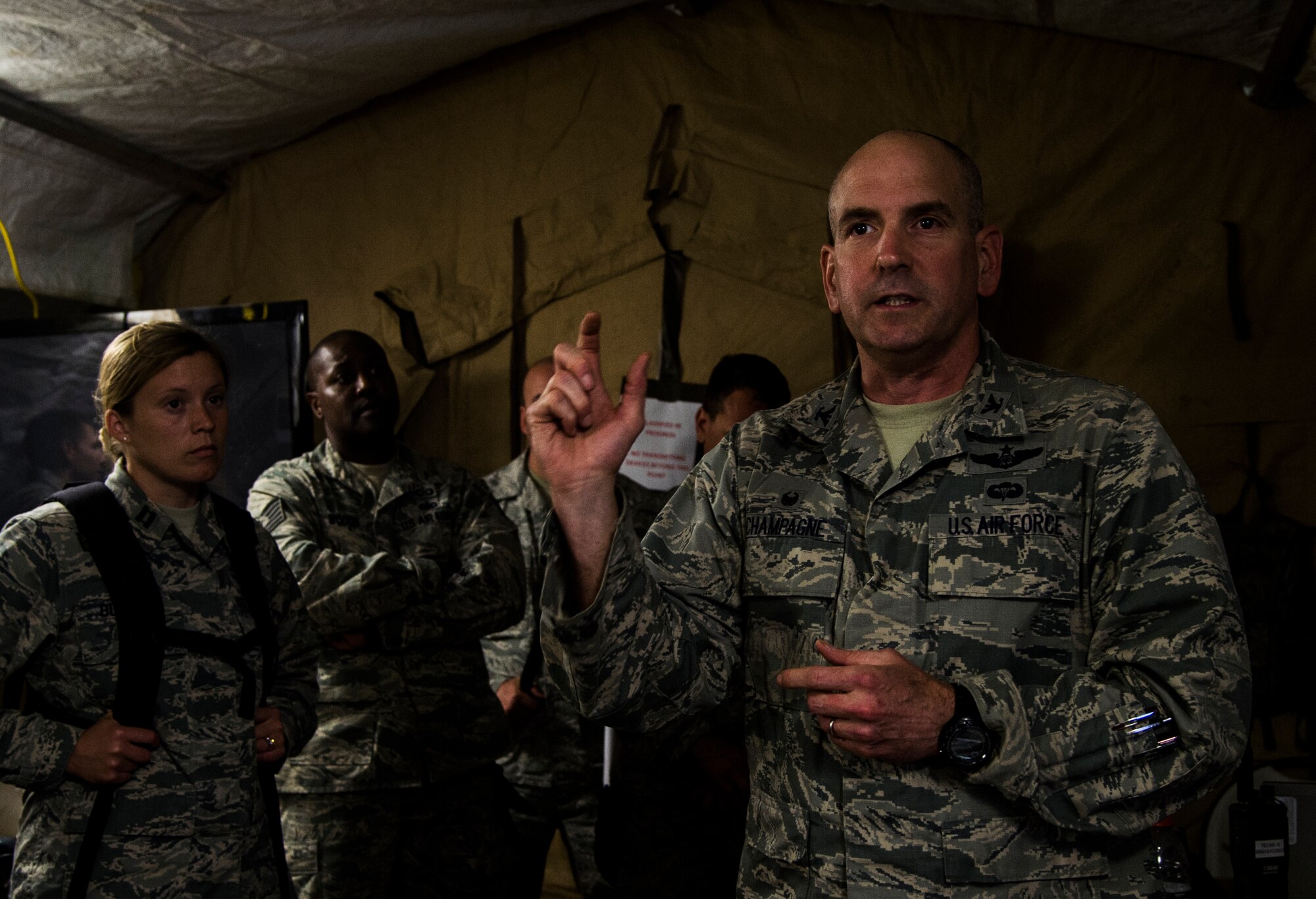 U.S. Air Force Colonel Rhett Champagne, 821st Contingency Response Group commander stationed at Travis Air Force Base, Calif., and Joint Task Force-Port Opening commander, speaks during an update brief during exercise Turbo Distribution 15-7 at Joint Base McGuire-Dix-Lakehurst, N.J., July 22, 2015. Approximately 106 Airmen stationed at Travis AFB, Calif., assigned to the 621st Contingency Response Wing, along with approximately 51 U.S. Army Soldiers assigned to the 690th Rapid Port Opening Element stationed at Joint Base Langley-Eustis, Va., and three members of the Defense Logistics Agency participated in the exercise, combining to make a Joint Task Force-Port Opening team. During the exercise, the U.S. Transportation Command tested the ability of the JTF-PO to distribute cargo during a humanitarian mission. (U.S. Air Force photo/Staff Sgt. Gustavo Gonzalez/RELEASED)