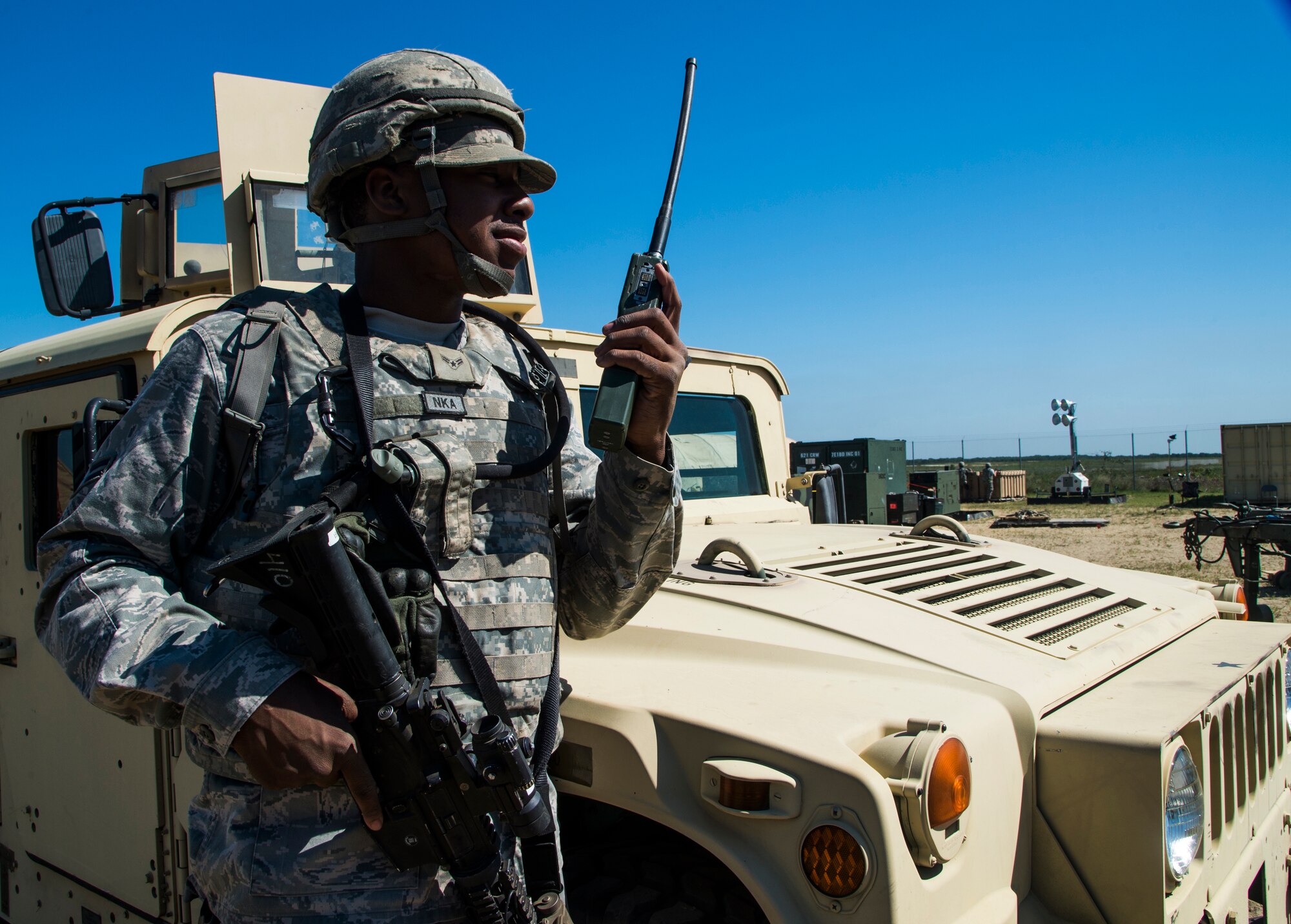 U.S. Air Force Airman 1st Class Kevin Kiner, assigned to the 621st Contingency Response Wing, talks into a radio during exercise Turbo Distribution 15-7 at Joint Base McGuire-Dix-Lakehurst, N.J., July 22, 2015. Approximately 106 Airmen stationed at Travis Air Force Base, Calif., assigned to the CRW, along with approximately 51 U.S. Army Soldiers assigned to the 690th Rapid Port Opening Element stationed at Joint Base Langley-Eustis, Va., and three members of the Defense Logistics Agency participated in the exercise, combining to make a Joint Task Force-Port Opening team. During the exercise, the U.S. Transportation Command tested the ability of the JTF-PO to distribute cargo during a humanitarian mission. (U.S. Air Force photo/Staff Sgt. Gustavo Gonzalez/RELEASED)