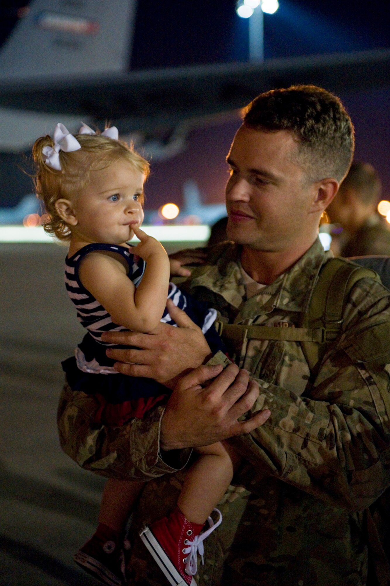 Staff Sgt. Dustin Fullerton, 434th Civil Engineer Squadron structural craftsman, holds his daughter, Piper, upon return to Grissom Air Reserve Base, Ind., July 22, 2015. Barone and 18 others from 434th CES members returned from a 180-day deployment to Southwest Asia. (U.S. Air Force photo/Tech. Sgt. Benjamin Mota)