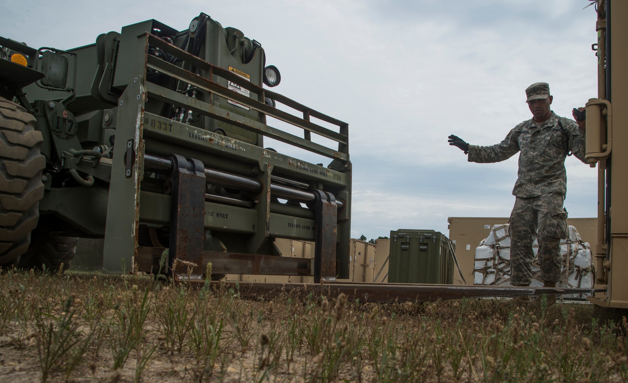 U.S. Army Soldiers assigned to the 690th Rapid Port Opening Element stationed at Joint Base Langley-Eustis, Va., use forklifts to load cargo onto trucks during exercise Turbo Distribution 15-7 at Joint Base McGuire-Dix-Lakehurst, N.J., July 21, 2015. Approximately 51 Soldiers along with approximately 106 U.S. Airmen stationed at Travis Air Force Base, Calif., assigned to the 621st Contingency Response Wing, and three members of the Defense Logistics Agency participated in the exercise, combining to make a Joint Task Force-Port Opening team. During the exercise, the U.S. Transportation Command tested the ability of the JTF-PO to distribute cargo during a humanitarian mission. (U.S. Air Force photo/Staff Sgt. Gustavo Gonzalez/RELEASED)