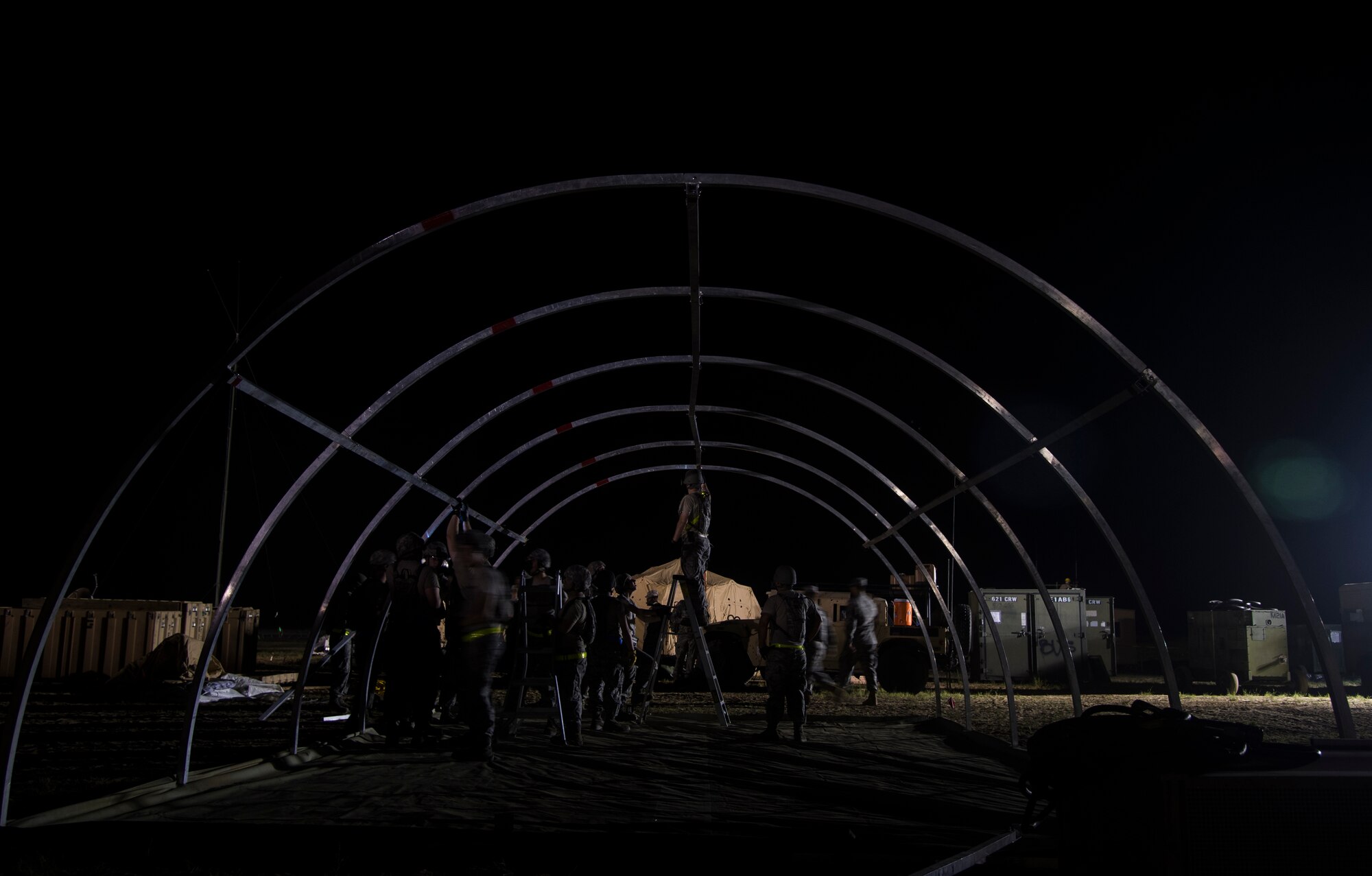 U.S. Air Force Airmen assigned to the 621st Contingency Response Wing help set up tents during exercise Turbo Distribution 15-7 at Joint Base McGuire-Dix-Lakehurst, N.J., July 21, 2015. Approximately 106 Airmen stationed at Travis Air Force Base, Calif., assigned to the CRW, along with approximately 51 U.S. Army Soldiers assigned to the 690th Rapid Port Opening Element stationed at Joint Base Langley-Eustis, Va., and three members of the Defense Logistics Agency participated in the exercise, combining to make a Joint Task Force-Port Opening team. During the exercise, the U.S. Transportation Command tested the ability of the JTF-PO to distribute cargo during a humanitarian mission. (U.S. Air Force photo/Staff Sgt. Gustavo Gonzalez/RELEASED)