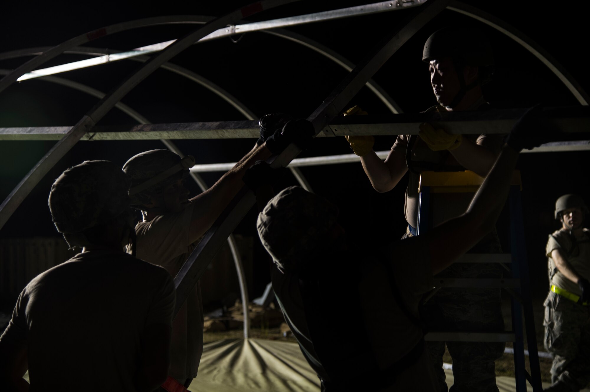 U.S. Air Force Airmen assigned to the 621st Contingency Response Wing help set up tents during exercise Turbo Distribution 15-7 at Joint Base McGuire-Dix-Lakehurst, N.J., July 21, 2015. Approximately 106 Airmen stationed at Travis Air Force Base, Calif., assigned to the CRW, along with approximately 51 U.S. Army Soldiers assigned to the 690th Rapid Port Opening Element stationed at Joint Base Langley-Eustis, Va., and three members of the Defense Logistics Agency participated in the exercise, combining to make a Joint Task Force-Port Opening team. During the exercise, the U.S. Transportation Command tested the ability of the JTF-PO to distribute cargo during a humanitarian mission. (U.S. Air Force photo/Staff Sgt. Gustavo Gonzalez/RELEASED)