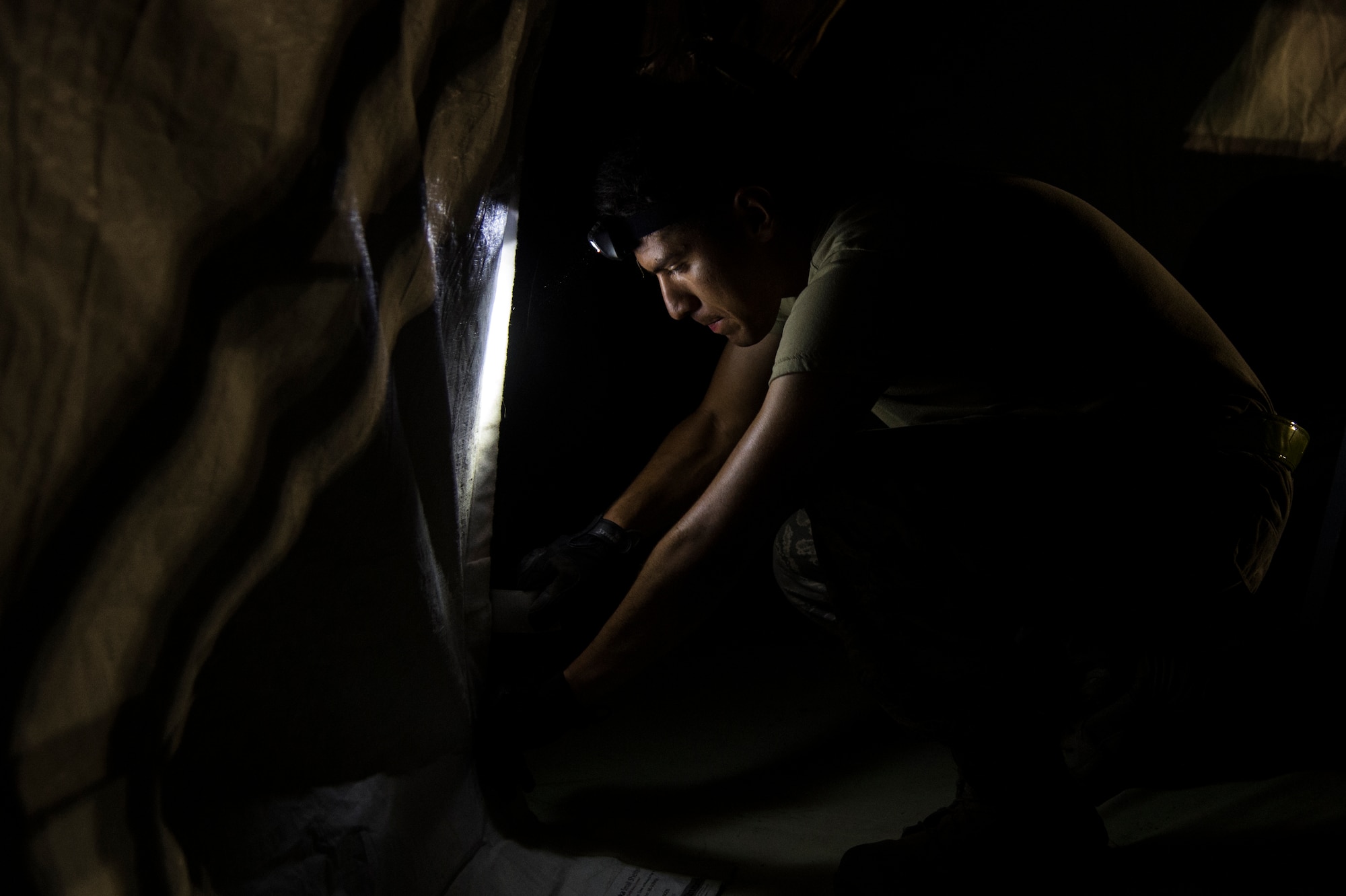 A U.S. Air Force Airman assigned to the 621st Contingency Response Wing helps set up tents during exercise Turbo Distribution 15-7 at Joint Base McGuire-Dix-Lakehurst, N.J., July 21, 2015. Approximately 106 Airmen stationed at Travis Air Force Base, Calif., assigned to the CRW, along with approximately 51 U.S. Army Soldiers assigned to the 690th Rapid Port Opening Element stationed at Joint Base Langley-Eustis, Va., and three members of the Defense Logistics Agency participated in the exercise, combining to make a Joint Task Force-Port Opening team. During the exercise, the U.S. Transportation Command tested the ability of the JTF-PO to distribute cargo during a humanitarian mission. (U.S. Air Force photo/Staff Sgt. Gustavo Gonzalez/RELEASED)