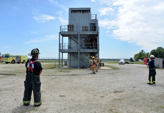Students from Sinclair Community College's Fire Academy participate in live fire training exercises at the Fire Training exercises at the Fire Training Center at Wright-Patterson Air Force Base July 16. The students are monitored by instructors from the college and fire fighters from Wright-Patterson AFB and the local community. (Air Force photo by Michelle Gigante)