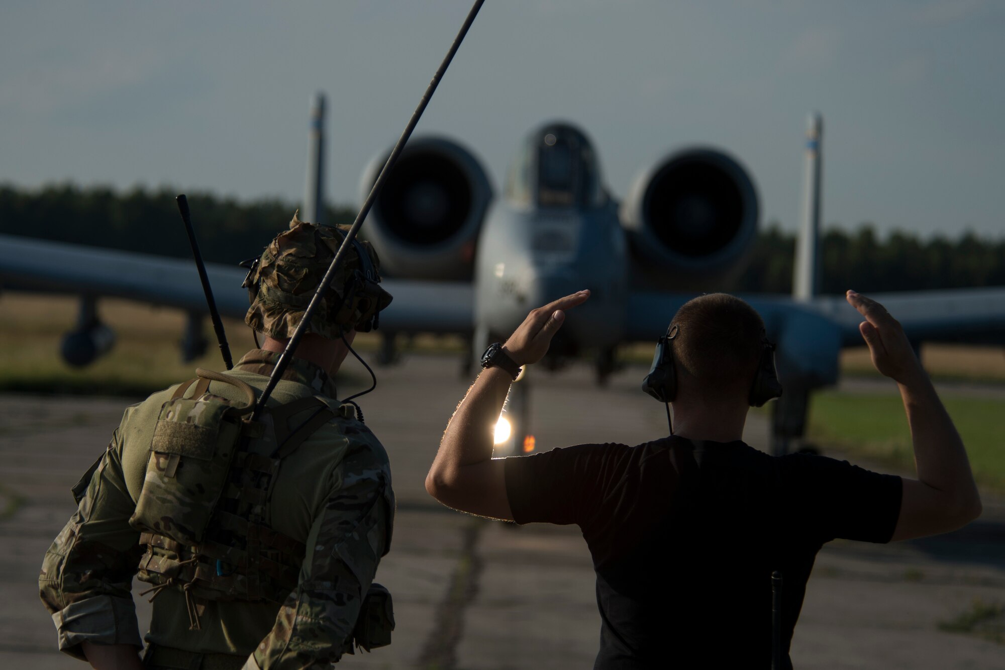 A 321st Special Tactics Squadron combat controller, left, stands by as a member of the Polish Special Forces directs an A-10C Thunderbolt II aircraft during training at Nowe Miasto, Poland, July 21, 2015. U.S. Airmen will conduct training alongside NATO allies to strengthen interoperability and demonstrate U.S. commitment to the security and stability of Europe. (U.S. Air Force photo by Airman 1st Class Luke Kitterman/Released)