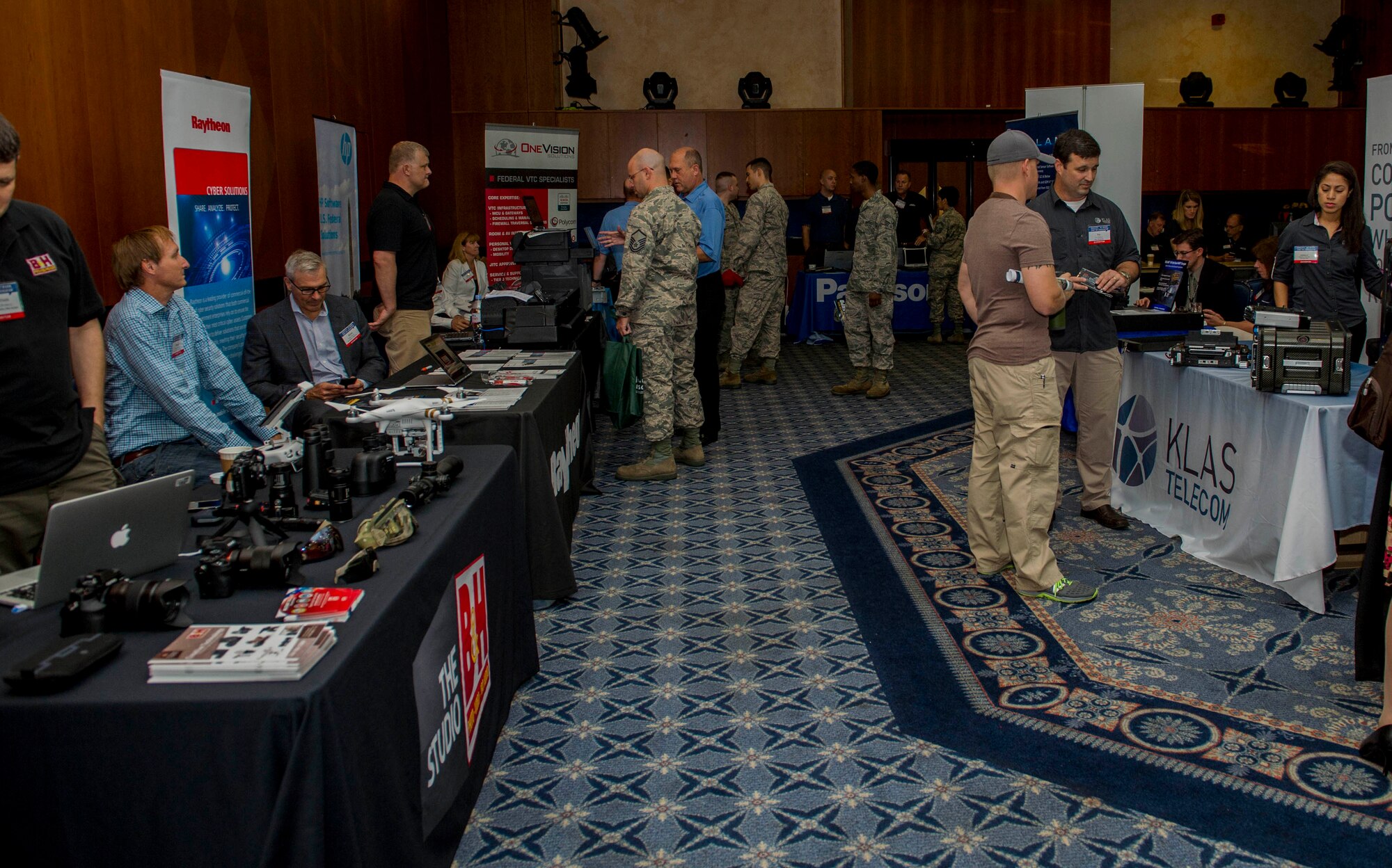 Technology industry representatives and base community members interact during the Tech Expo at Club Eifel on Spangdahlem Air Base, Germany, July 22, 2015. The Tech Expo allows base community members and representatives in the technology industry to come together and share, discuss and network. (U.S. Air Force photo by Airman 1st Class Timothy Kim/Released)