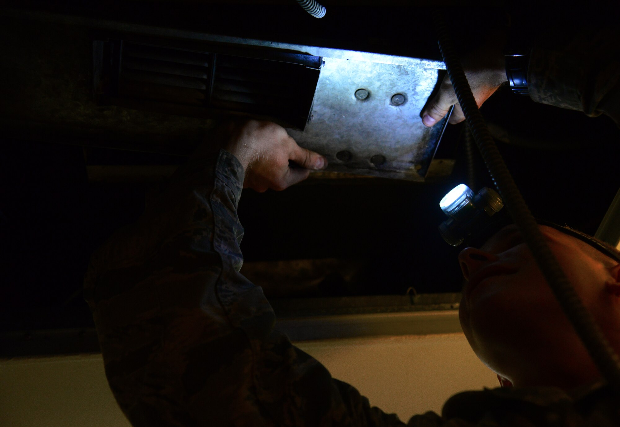 Airman 1st Class Evan Evans, 51st Civil Engineer Squadron heating, ventilation and air conditioning/refrigeration apprentice, works to replace the fan in a dormitory room at Osan Air Base, Republic of Korea, July 10, 2015.  Evans is part of the skilled team of technicians that keep Osan’s air running year round. 
(U.S. Air Force photo/Staff Sgt. Amber Grimm)