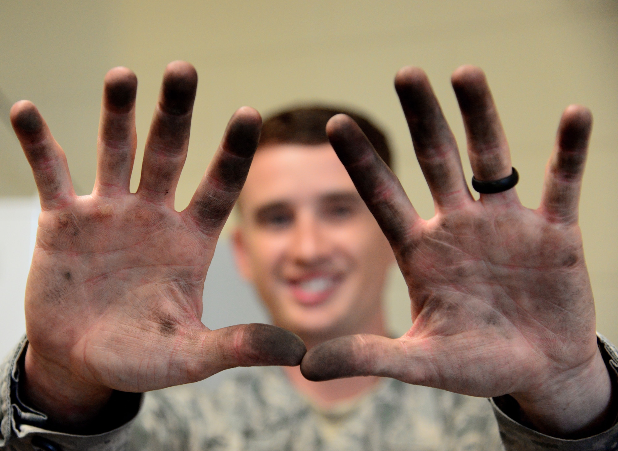 Senior Airman Cory Willis, 51st Civil Engineer Squadron heating, ventilation and air conditioning/refrigeration journeyman, displays his grease covered hands after working back to back jobs at Osan Air Base, Republic of Korea July 10, 2015. Up to their elbows in oil, dirty water, grease, soot and sweat, an HVAC/R Airman’s job certainly qualifies as a dirty one. 
(U.S. Air Force photo/Staff Sgt. Amber Grimm)