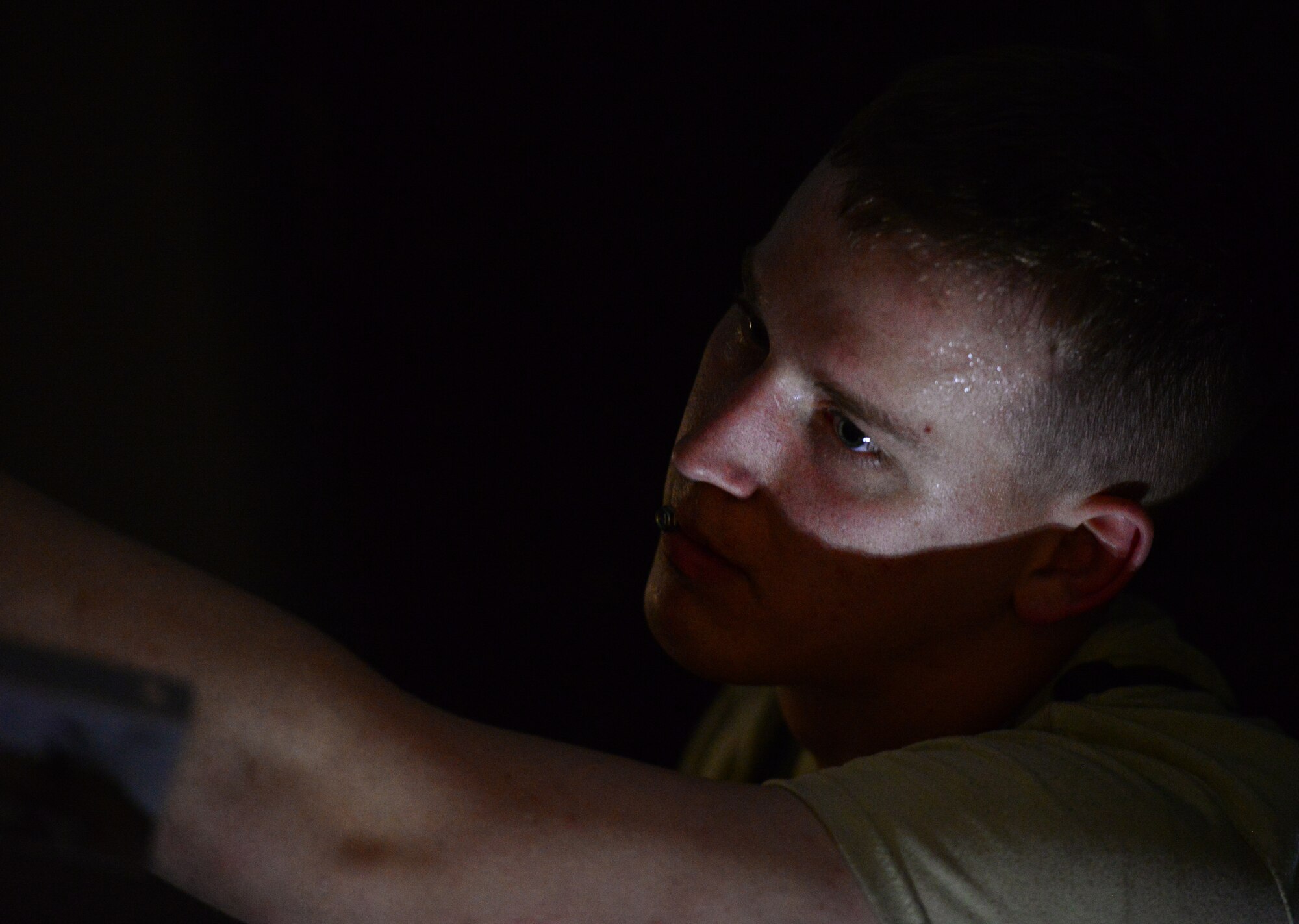 With his brow covered in sweat, Airman 1st Class Dalton Hasselbring, 51st Civil Engineer Squadron heating, ventilation and air conditioning apprentice, works inside an air conditioning unit in the dormitories on Osan Air Base, Republic of Korea May 13, 2015. The workspace is narrow, dark and with the heat rising steadily, uncomfortably, he ensures the job gets done and the rest of the base stays cool. 
(U.S. Air Force photo/Staff Sgt. Amber Grimm)