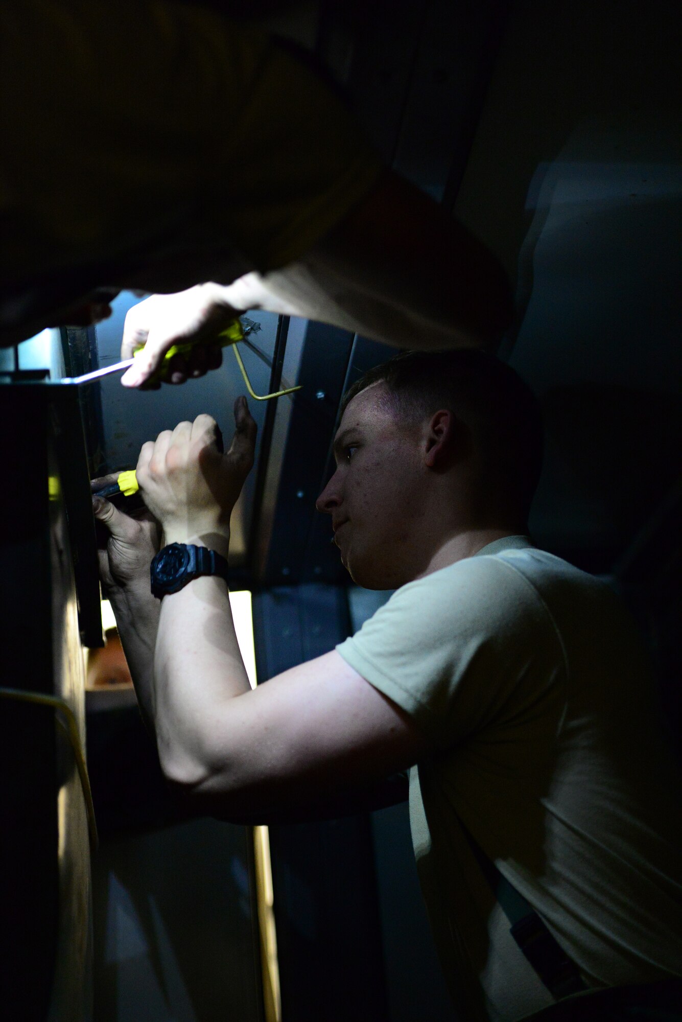 Airman 1st Class Dalton Hasselbring, 51st Civil Engineer Squadron heating, ventilation and air conditioning apprentice, works inside an air conditioning unit in the dormitories on Osan Air Base, Republic of Korea, May 13, 2015. The workspace is narrow, dark and with the heat rising steadily, uncomfortably, he ensures the job gets done and the rest of the base stays cool.
(USAF photo by Staff Sgt. Amber Grimm)
