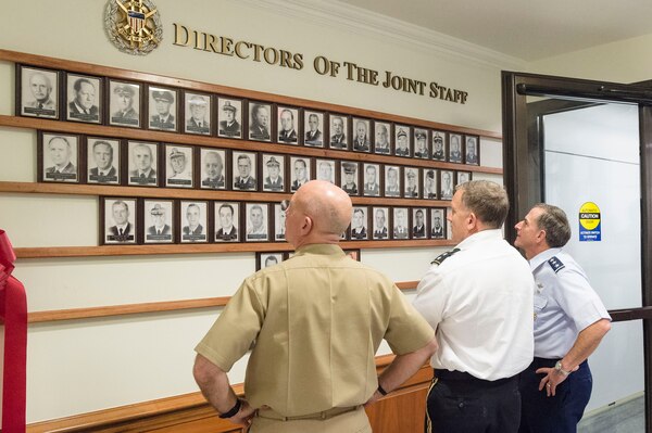 Vice Adm. Kurt Tidd, assistant to the Chairman of the Joint Chiefs of Staff, Lt. Gen. William Mayville Jr., J-3 Director for Operations and Lt. Gen. David Goldfein, Director of the Joint Staff, look at the newly unveiled portrait board at the Pentagon, July 23, 2015. The board contains the images of past directors of the Joint Staff.