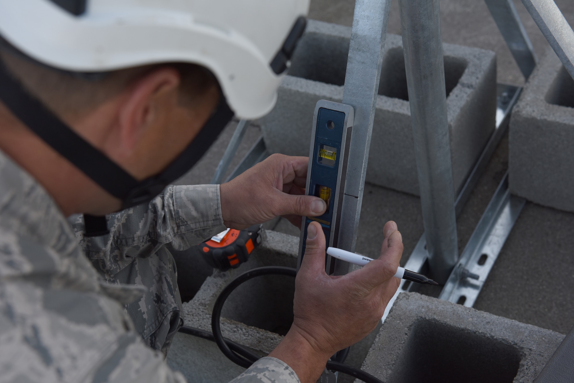 Tech. Sgt. Jason Gordner, cable team member, 211th Engineering Installation Squadron, works to mark the placement of a bus bar on an antenna on the roof of a hanger of the 168th Air Refueling Wing, Eielson Air Force Base, Fairbanks, Alaska. Gordner is a part of the eight-person antenna grounding project the 211th EIS is completing as part of  Exercise Frosty Spear, 168th ARW. (U.S. Air National Guard photo by Staff Sgt. Claire Behney)