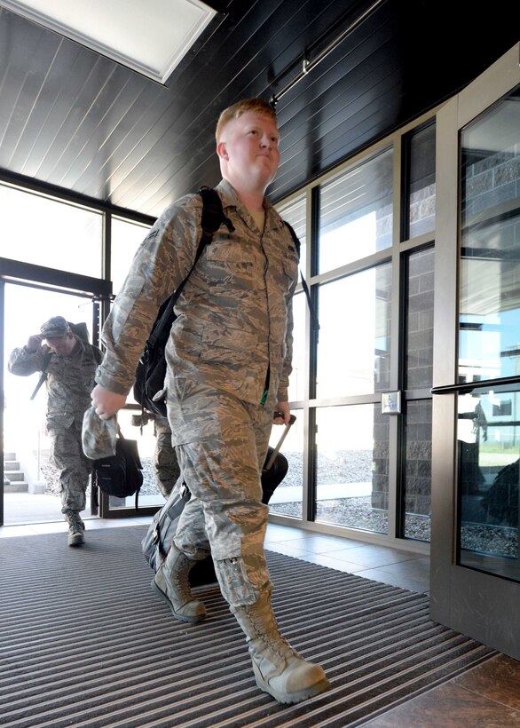 Airman 1st Class Connor, 28th Munitions Squadron storage crew member, enters the Deployment Center at Ellsworth Air Force Base, S.D., July 24, 2015. The facility provides a centralized location for Airmen to complete the many steps required prior to deployment, streamlining the process for departing personnel. (U.S. Air Force photo by Senior Airman Rebecca Imwalle/Released)

