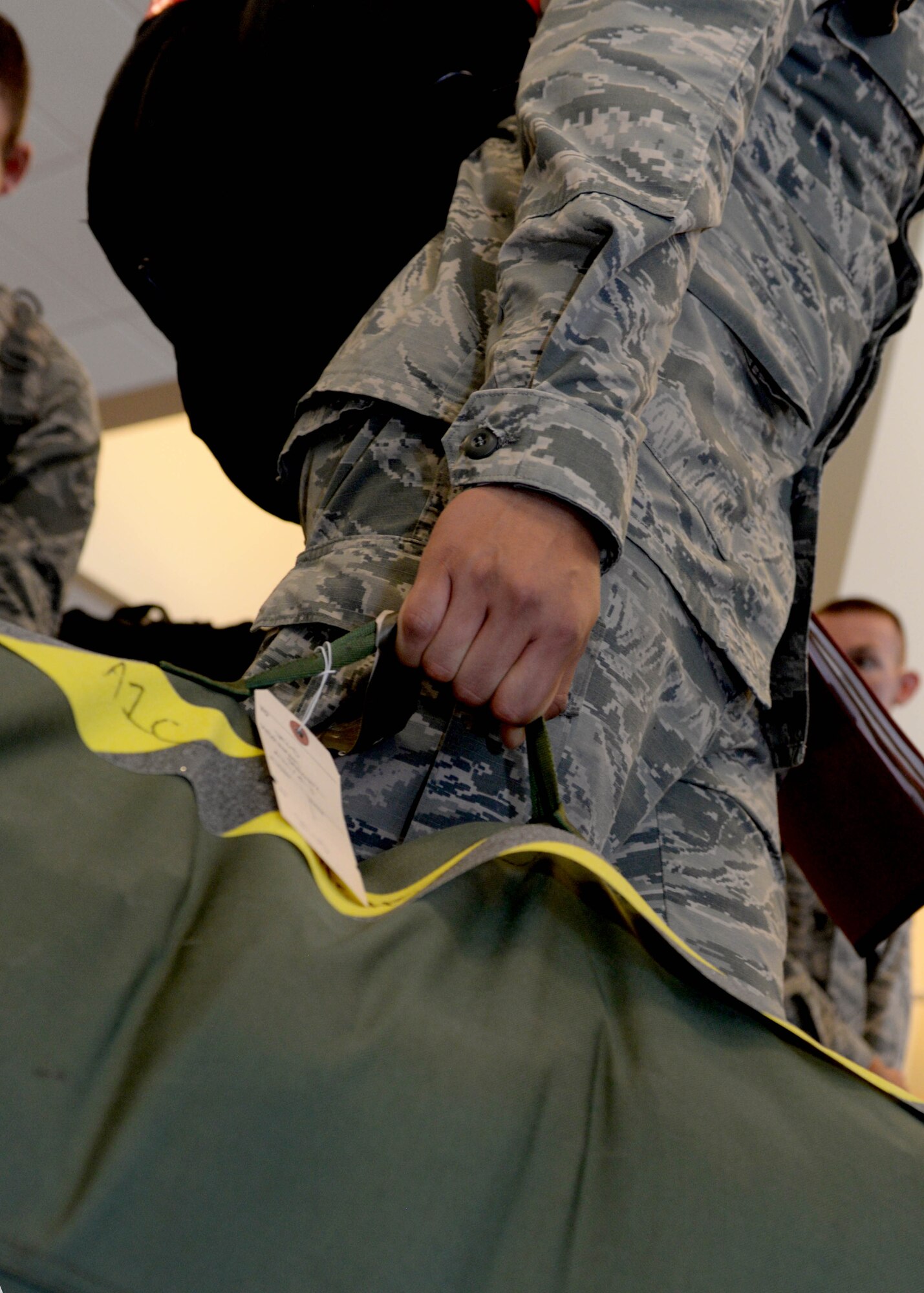 An Ellsworth Airman picks up his luggage at the Deployment Center at Ellsworth Air Force Base, S.D., July 24, 2015. Deploying personnel will provide combatant commanders critical air presence, precision strike and surveillance and reconnaissance capabilities. (U.S. Air Force photo by Senior Airman Rebecca Imwalle/Released)

