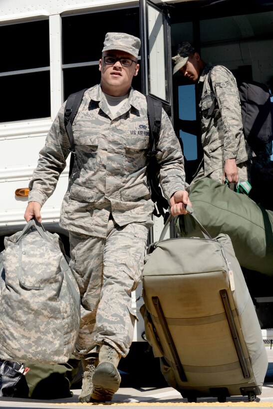 Senior Airman Justin, 28th Munitions Squadron conventional maintenance crew chief, unloads luggage at the Deployment Center, Ellsworth Air Force Base, S.D., July 24, 2015. Justin is one of more than 350 Airmen deploying to Southwest Asia in support of Operation’s Freedom’s Sentinel and Inherent Resolve. (U.S. Air Force photo by Senior Airman Rebecca Imwalle/Released)

