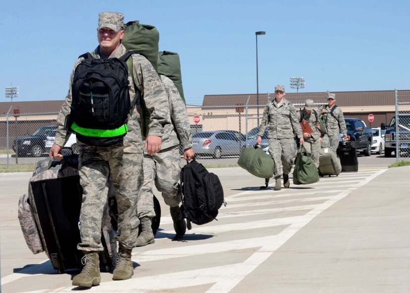 Airmen assigned to the 28th Bomb Wing prepare to process through the Deployment Center at Ellsworth Air Force Base, S.D., July 24, 2015, prior to departure to Southwest Asia. Training and preparation has equipped aircrews, maintenance and support personnel from Ellsworth with the ability to successfully execute B-1 bomber missions in support of U.S. and coalition forces. (U.S. Air Force photo by Senior Airman Rebecca Imwalle/Released)