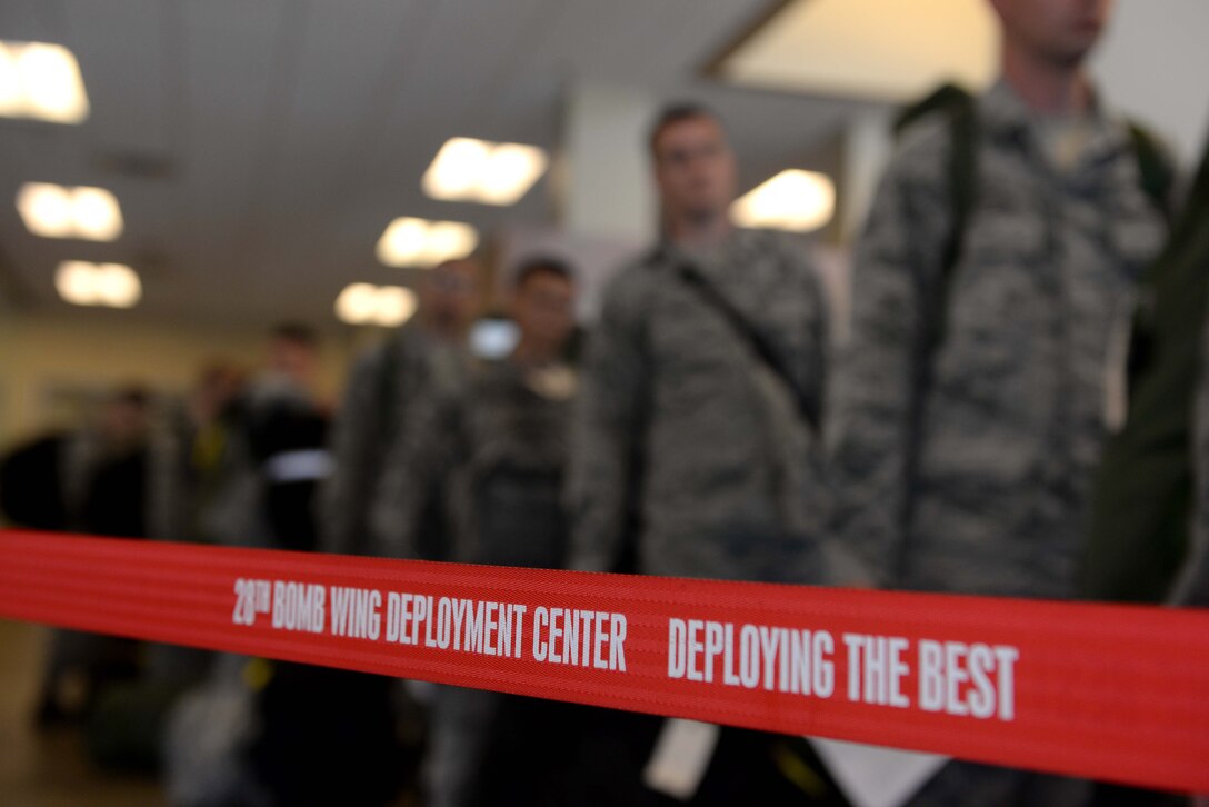 Airmen of the 28th Bomb Wing prepare to go through a mobility-line at the Deployment Center, Ellsworth Air Force Base, S.D., July 24, 2015. More than 350 Airmen departed to Southwest Asia for a six-month deployment, helping ensure multi-role airpower success in the U.S. Central Command area of responsibility. (U.S. Air Force photo by Senior Airman Rebecca Imwalle/Released)