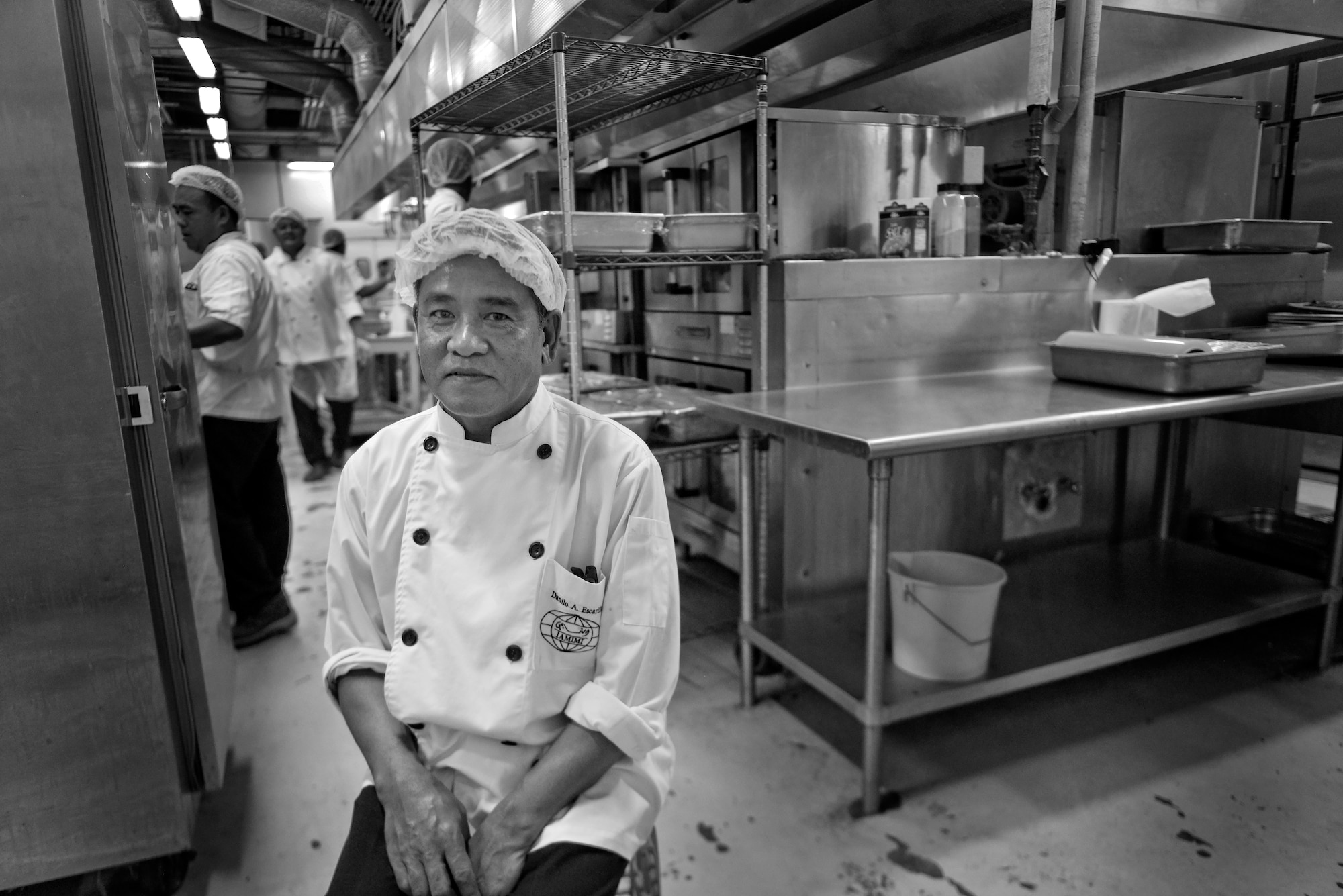 Danilo "Danny" Escarilla sits in the kitchen as breakfast preparations come to an end and lunch begins at the Independence Dinning Facility at Al Udeid Air Base, Qatar July 21, 2015. Escarilla has been working at the Independence Dining Facility for over eight years and is now the head cook. (U.S. Air Force photo/Staff Sgt. Alexandre Montes)