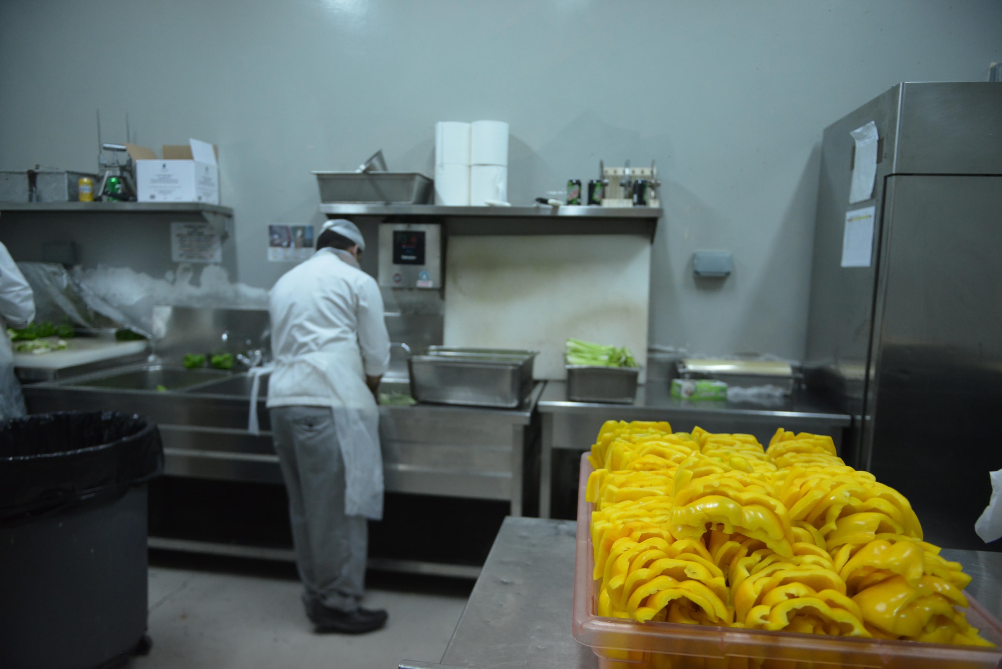 Dining facility cooks wash and cut vegetables to prepare the salad bar at the Independence Dining Facility at Al Udeid Air Base, Qatar July 21, 2015. (U.S. Air Force photo/Staff Sgt. Alexandre Montes)