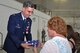 Col. Donald Robison, commander, 459 Maintenance Group, Joint Base Andrews, Maryland, presents a folded United States of America flag to his wife Sarah at his retirement ceremony at JB Andrews, July 25, 2015.  Col. Robison retires from the Air Force Reserve after culminating 27 years of service in the Air Force.  (U.S. Air Force photo by: Tech. Sgt. Brent A. Skeen)