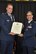 Col. William Mason, chief of the operations, training, and standardization division for the joint staff deputy director of nuclear, homeland defense and current operations, Pentagon, Washington D.C., presents Col. Donald Robison, commander, 459 Maintenance Group, Joint Base Andrews, Maryland, a certificate for retirement, at JB Andrews, July 25, 2015.  Col. Robison retires from the Air Force Reserve, culminating 27 years of service in the Air Force.  (U.S. Air Force photo by: Tech. Sgt. Brent A. Skeen)