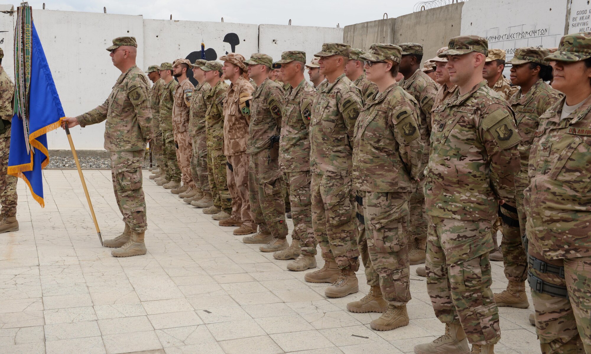 Members of the Train, Advise, Assist Command-Air (TAAC-Air) stand in formation during a change of command ceremony July 27, 2015, at Hamid Karzai International Airport, Kabul, Afghanistan. Brig. Gen. Christopher E. Craige took command of the TAAC-Air, 438th Air Expeditionary Wing during a ceremony here July 27, 2015. Presiding at the ceremony was Gen. John F. Campbell, commander, Resolute Support and U.S. Forces-Afghanistan. (U.S. Air Force photo by Senior Airman Cierra Presentado/Released)