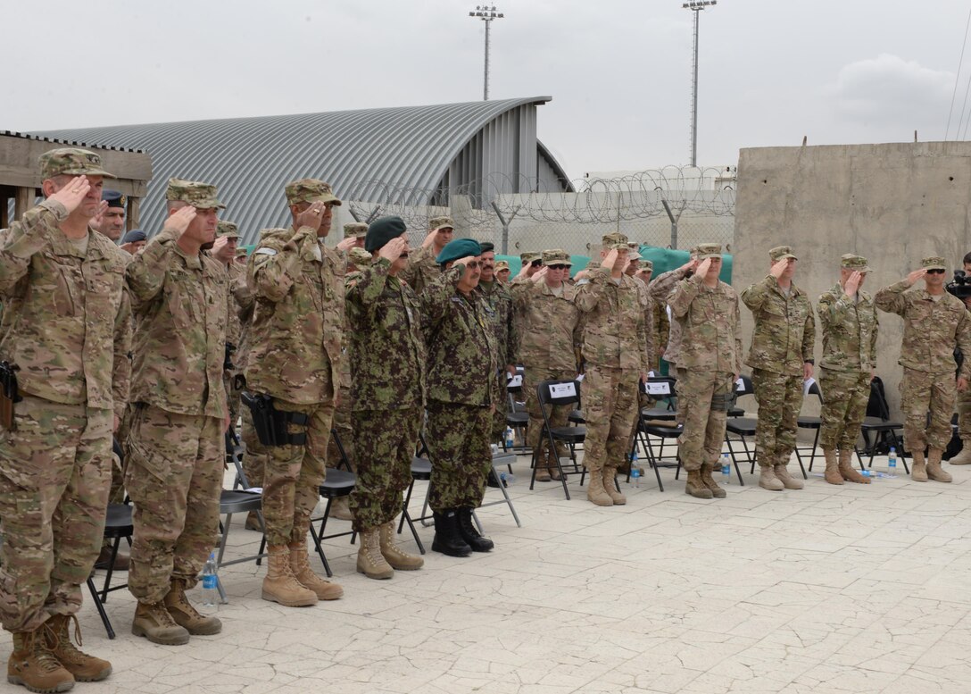 Coalition and Afghan military personnel salute the U.S. and Afghan flags at a change of command ceremony July 27, 2015, at Hamid Karzai International Airport, Kabul, Afghanistan. Brig. Gen. Christopher E. Craige took command of the Train, Advise, Assist Command – Air (TAAC-Air), 438th Air Expeditionary Wing. Presiding at the ceremony was Gen. John F. Campbell, commander, Resolute Support and U.S. Forces-Afghanistan. (U.S. Air Force photo by Senior Airman Cierra Presentado/Released)