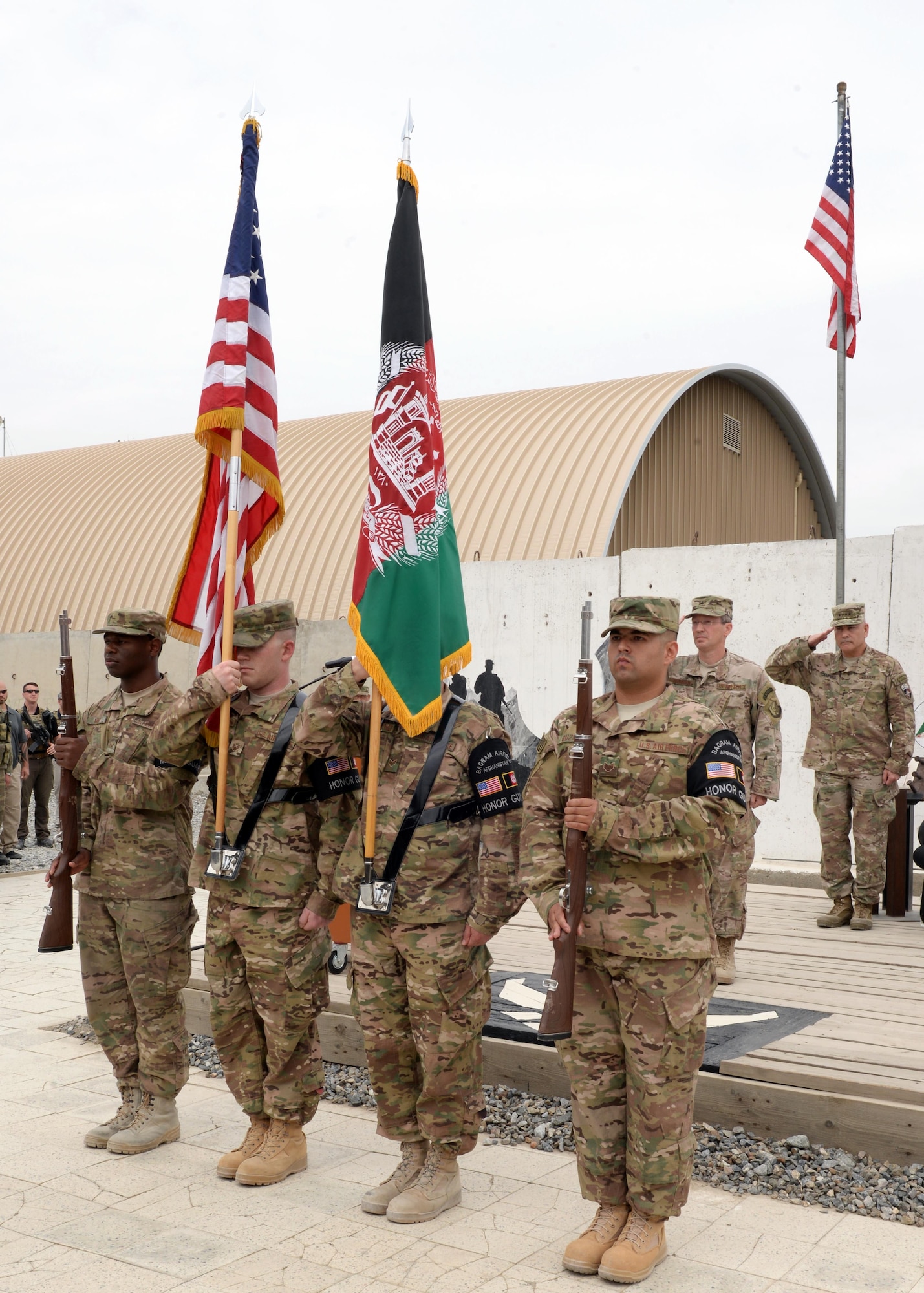 Honor guard members from the 455th Air Expeditionary Wing, Bagram Air Field, Afghanistan, present the colors during a change of command ceremony July 27, 2015, at Hamid Karzai International Airport, Kabul, Afghanistan. Brig. Gen. Christopher E. Craige took command of the Train, Advise, Assist Command – Air (TAAC-Air), 438th Air Expeditionary Wing. Presiding at the ceremony was Gen. John F. Campbell, commander, Resolute Support and U.S. Forces-Afghanistan. (U.S. Air Force photo by Senior Airman Cierra Presentado/Released)