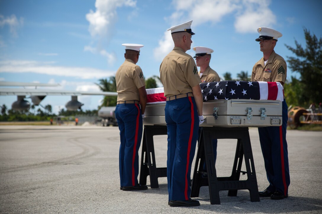 3rd Marine Regiment pallbearers prepare to escort a casket of remains onto a C-130J Hercules aircraft, July 25, 2015, during a repatriation ceremony in Tarawa, Kiribati. The ceremony honored the remains of approximately 36 Marines who fought and died during the Battle of Tarawa in World War II, and are being transported back to the United States for proper identification and final burial. 