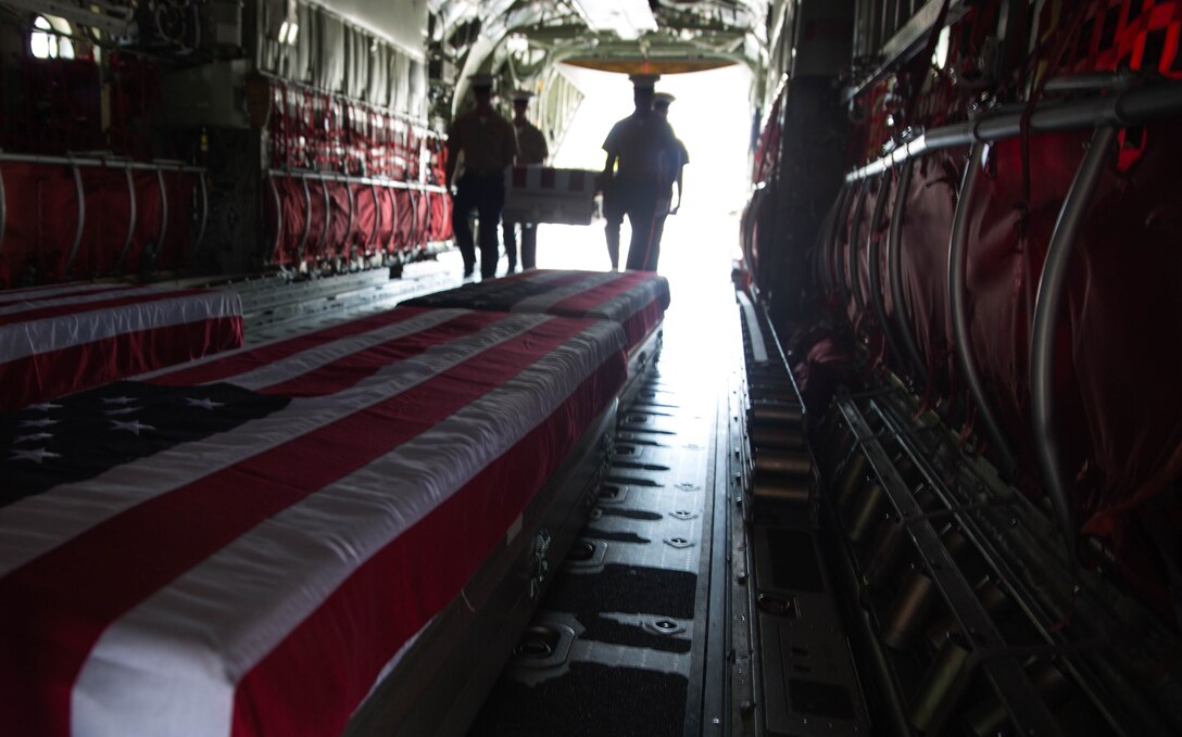 Caskets holding the remains of approximately 36 Marines who fought and died during the Battle of Tarawa in World War II are loaded onto a C-130J Hercules aircraft, July 25, 2015, during a repatriation ceremony in Tarawa, Kiribati. The remains will be transported back to the United States for proper identification and burial. (U.S. Marine Corps photo by Cpl. Matthew J. Bragg)