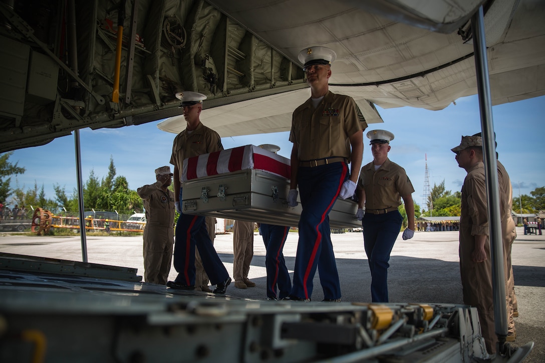 3rd Marine Regiment  pallbearers carry a casket onto a C-130J Hercules aircraft, July 25, 2015, during a repatriation ceremony in Tarawa, Kiribati. The caskets held the remains of approximately 36 Marines who fought and died during the Battle of Tarawa in World War II. The remains will be transported back to the United States for proper identification and final burial. 