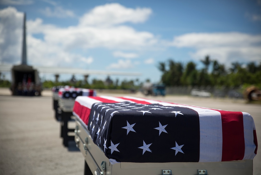 Caskets carrying the remains of approximately 36 Marines rest on the tarmac, July 25, 2015, in Tarawa, Kiribati, before a repatriation ceremony. The remains were honored during the ceremony and loaded onto a C-130J Hercules aircraft for their return home to the United States where they will be identified and laid to rest in their final resting place. 
