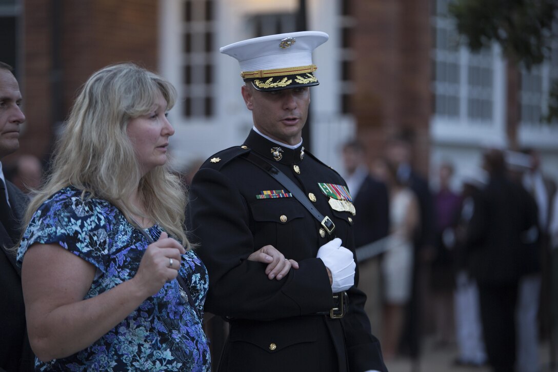 Maj. John Morgan from Marine Barracks Washington, D.C., escorts a guest of the Friday Evening Parade, July 24, 2015. The guest of honor for the Evening Parade was Adm. Jonathan Greenert, chief of naval operations, and the hosting official for that same parade was Gen. Joseph Dunford Jr., commandant of the Marine Corps. (Official Marine Corps photo by Cpl. Chi Nguyen/Released)